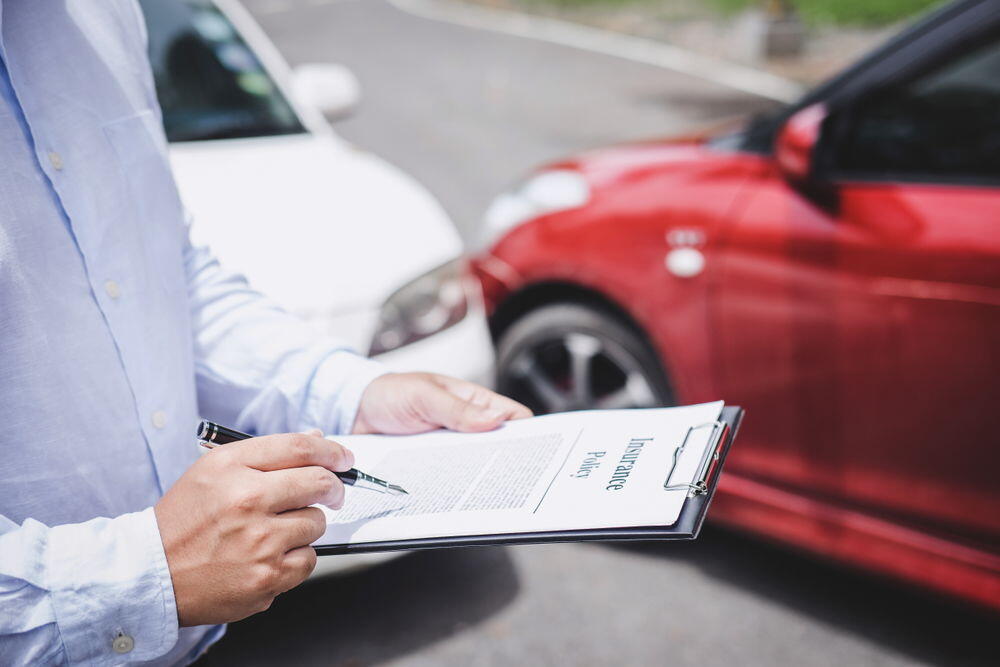 Insurance policy being reviewed for a car accident