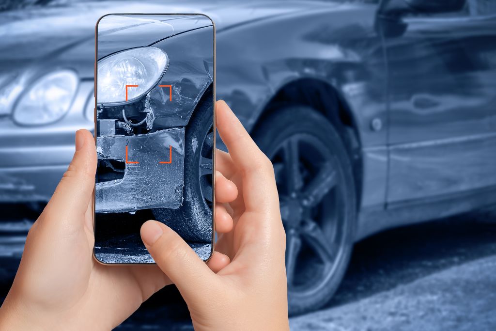 taking a picture of the damage from a car accident