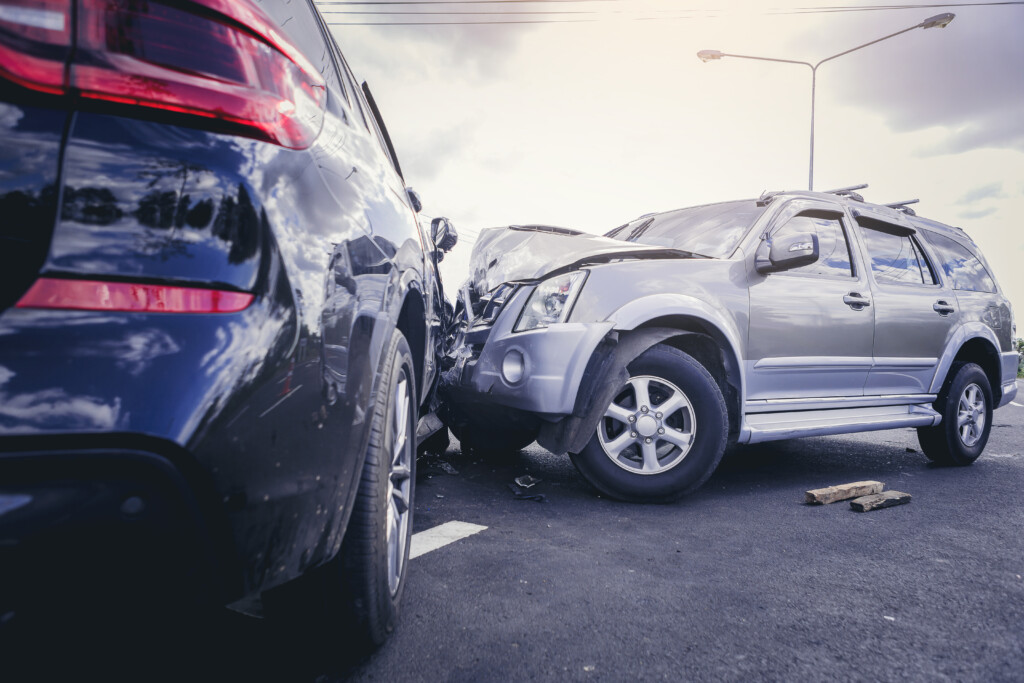 grey car and blue car in a head on accident